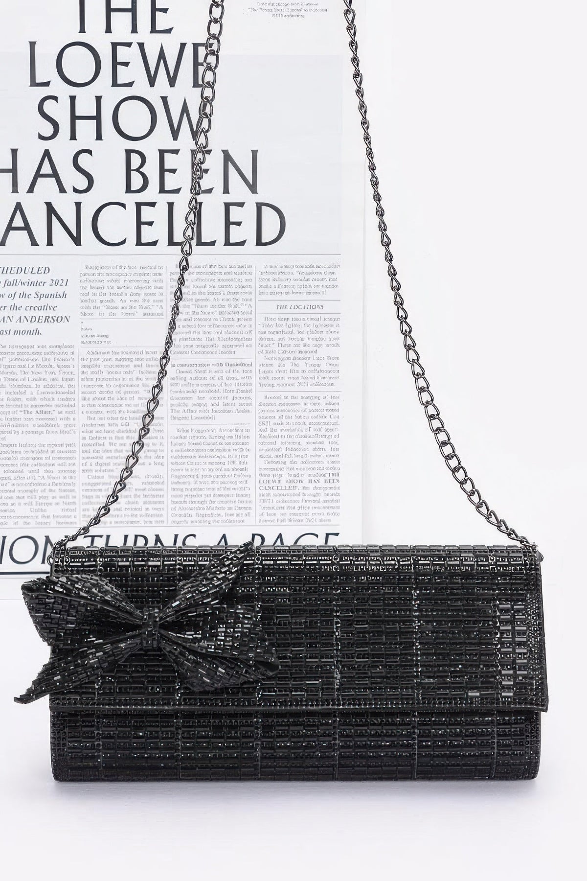 Black beaded clutch with bow detail and long chain strap