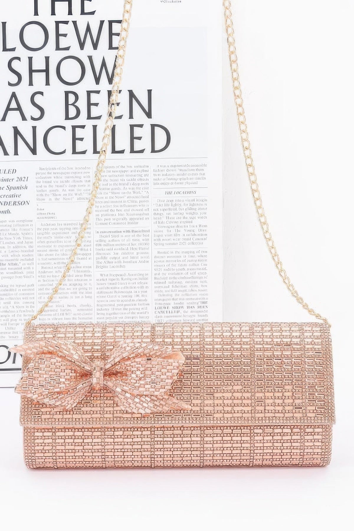 Rose gold beaded clutch with large bow and chain shoulder strap