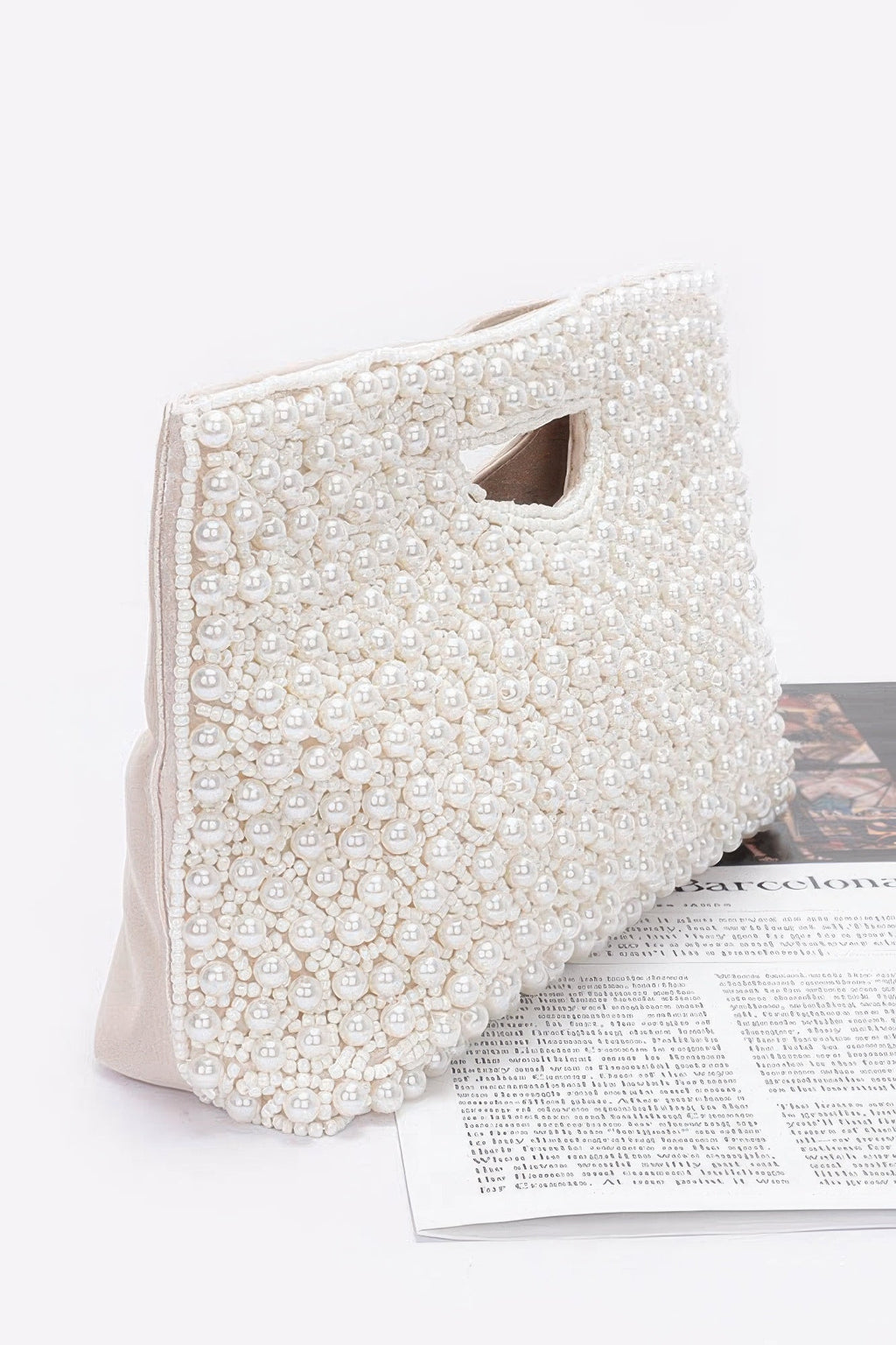 Cream beaded clutch bag side view with textured bead surface