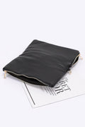Black zip clutch with chain strap attachment and smooth back panel, gold-tone hardware