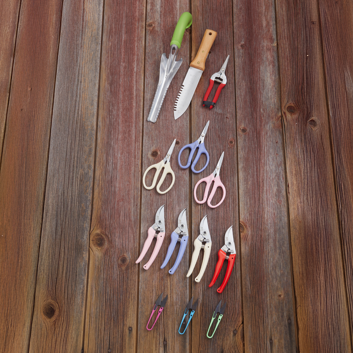 Assorted Hori Hori digging tools with serrated blades and wooden handles