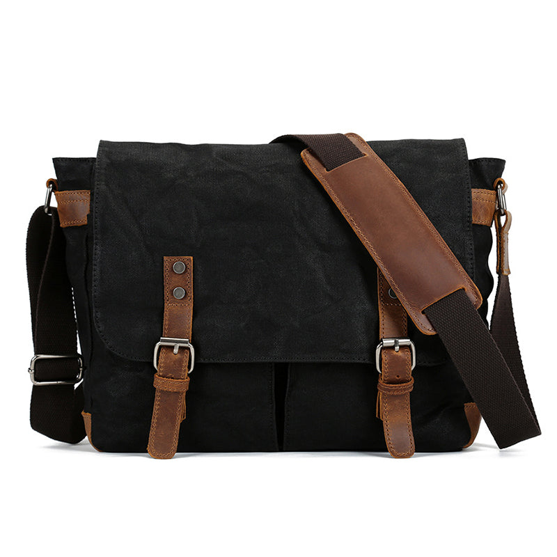 Waxed canvas crossbody messenger bag, black with front flap and leather buckle straps.