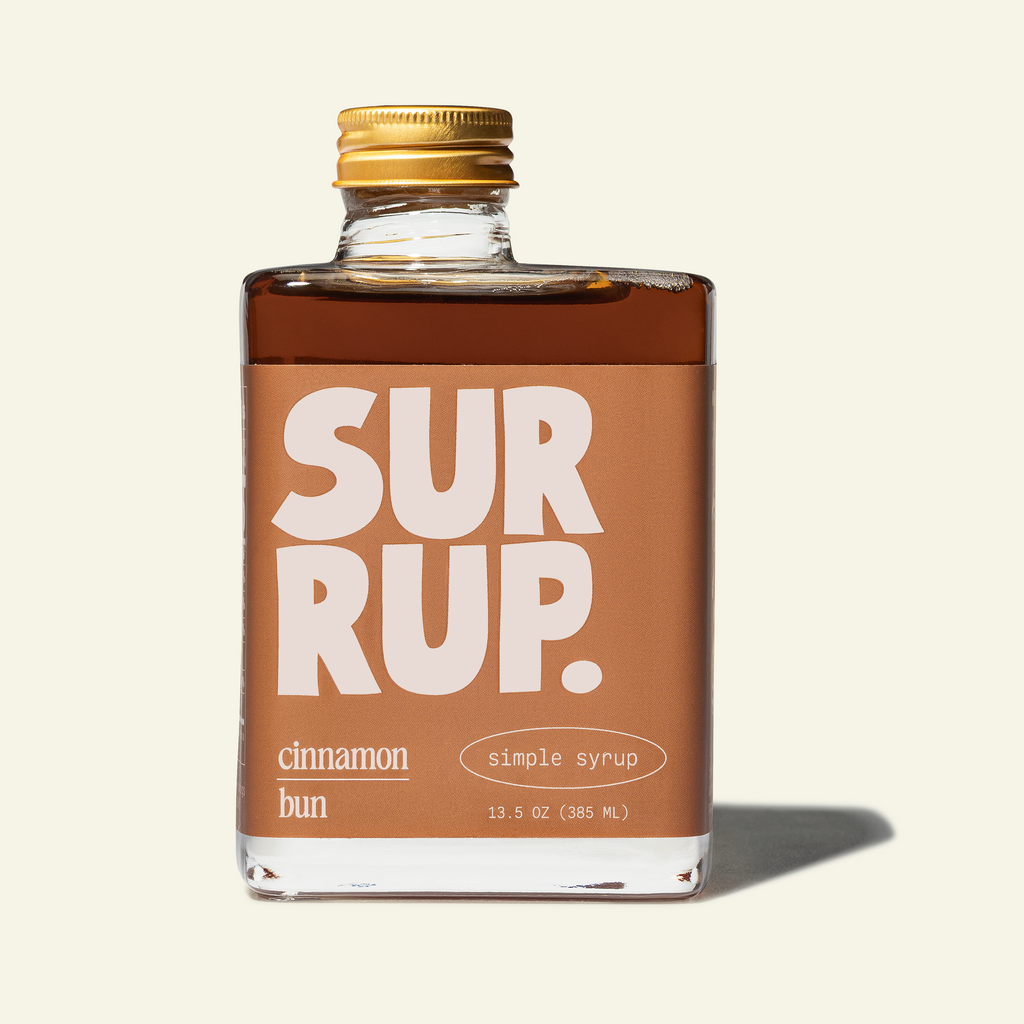 Cinnamon bun syrup bottle with gold cap, clear glass, SUR RUP label.