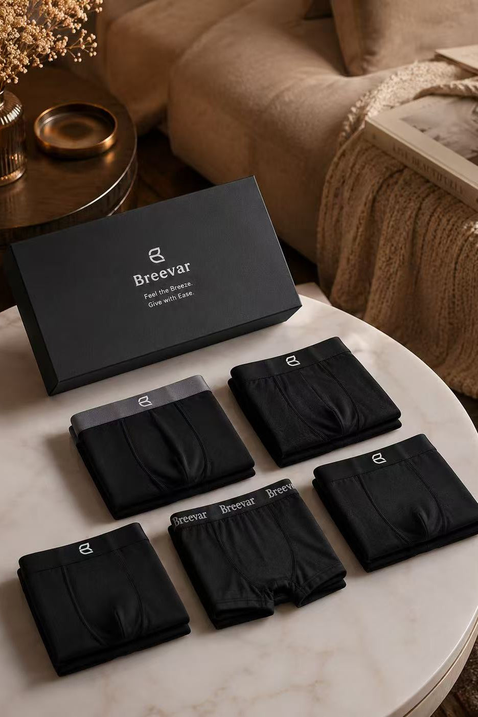 Gift box set of folded black boxer briefs arranged on a round tray