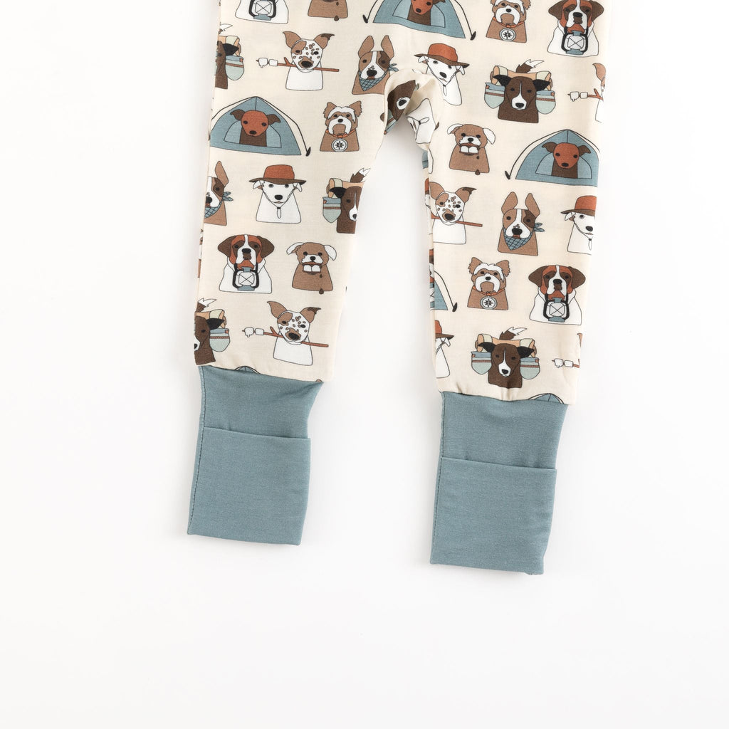 Cream dog-print footie pajama legs with blue-gray cuffed openings