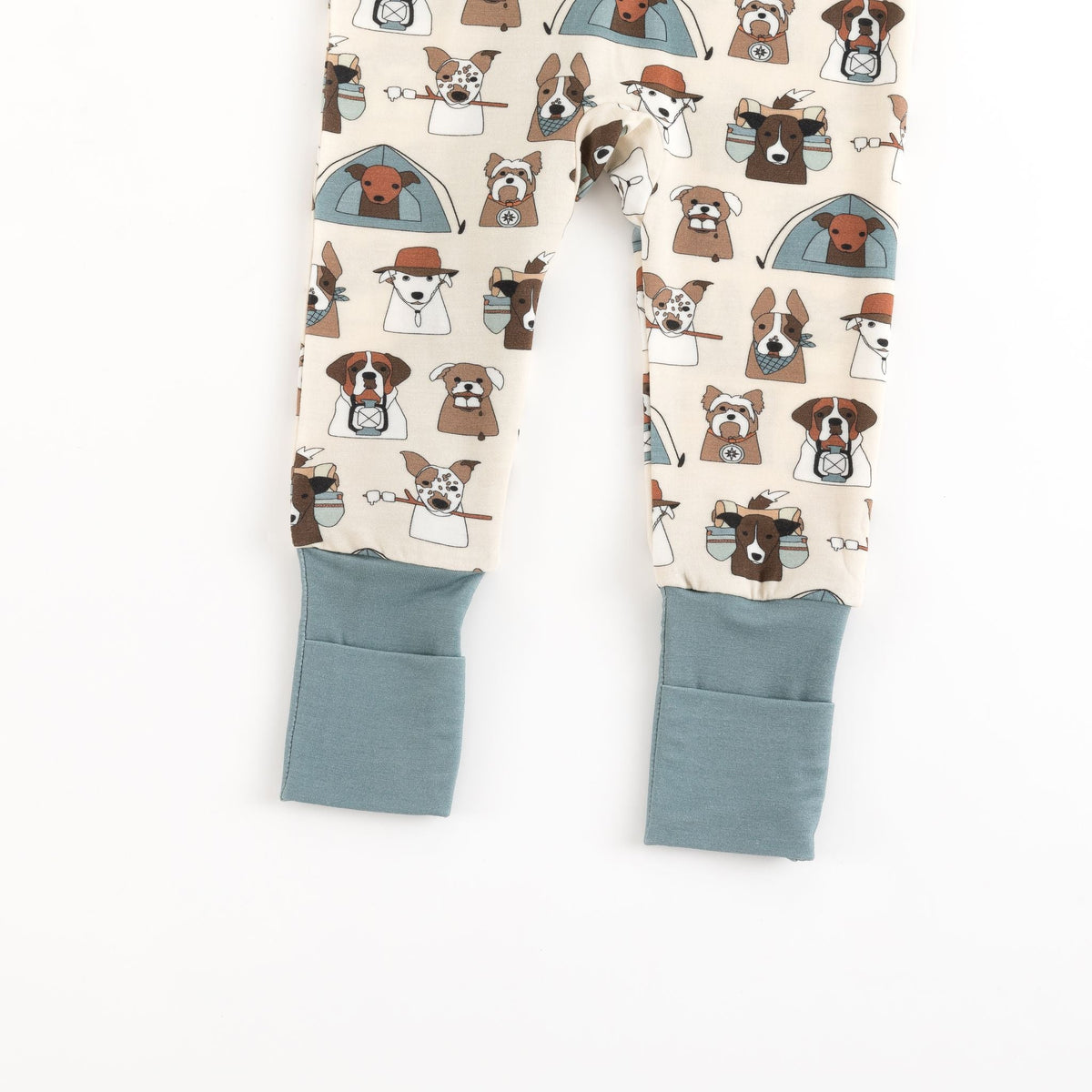 Cream dog-print footie pajama legs with blue-gray cuffed openings