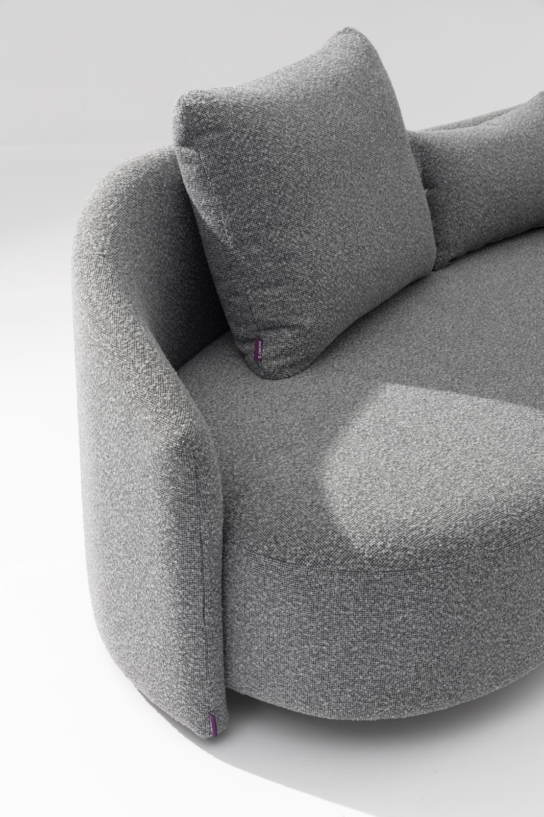 Gray outdoor lounge sofa with curved armrest and two upholstered cushions