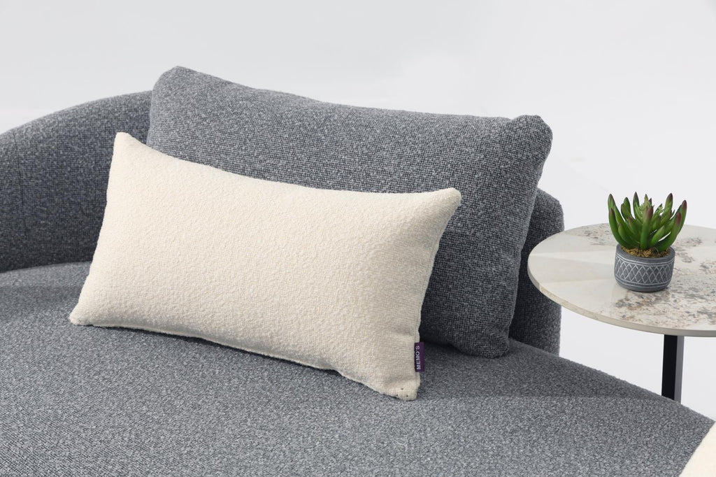 Gray cushioned outdoor chair with light square pillow