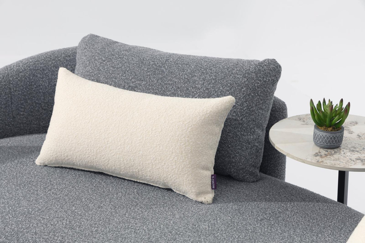 Gray cushioned outdoor chair with light square pillow