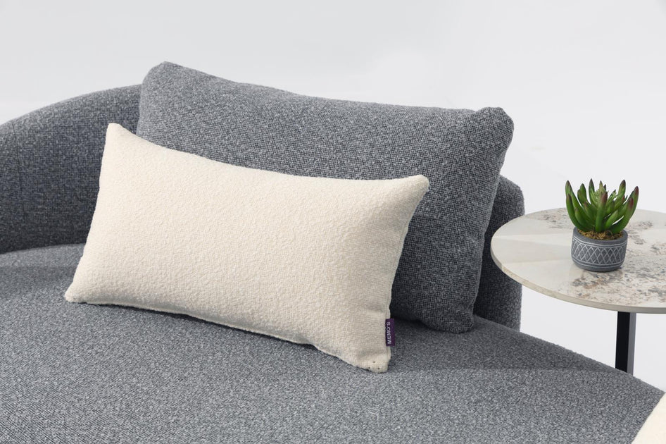 Outdoor sofa with gray bouclé fabric and cream lumbar pillow