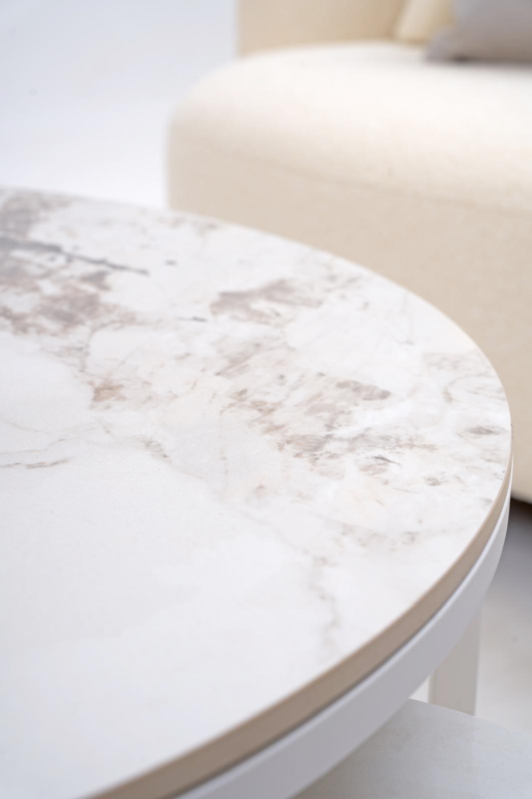 Round coffee table with white marble-look top and smooth light-gray side