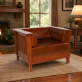 Brown leather craftsman side arm chair with slat wood sides and cushioned arms.