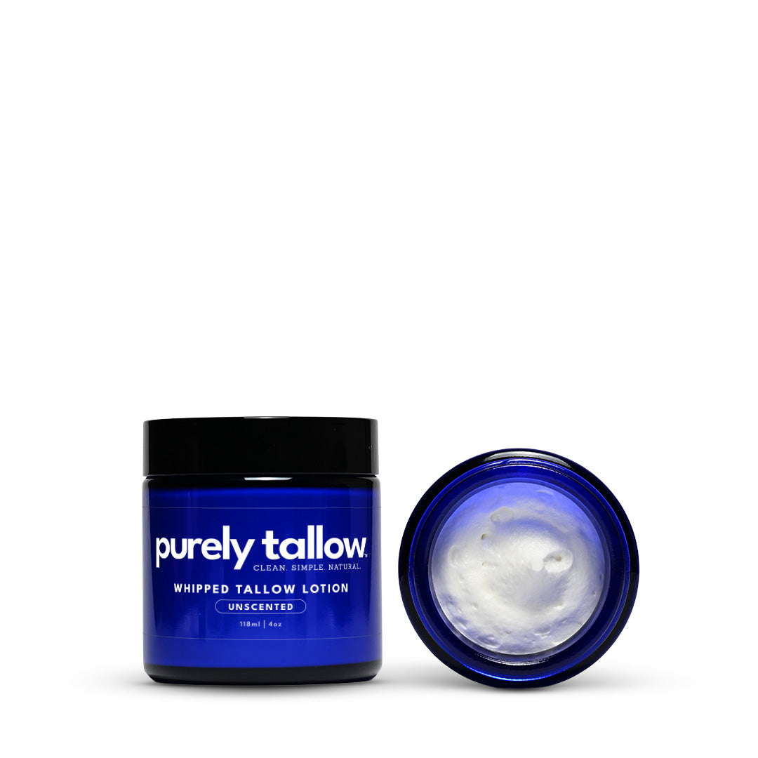 Whipped tallow lotion jar with lid open, white cream inside