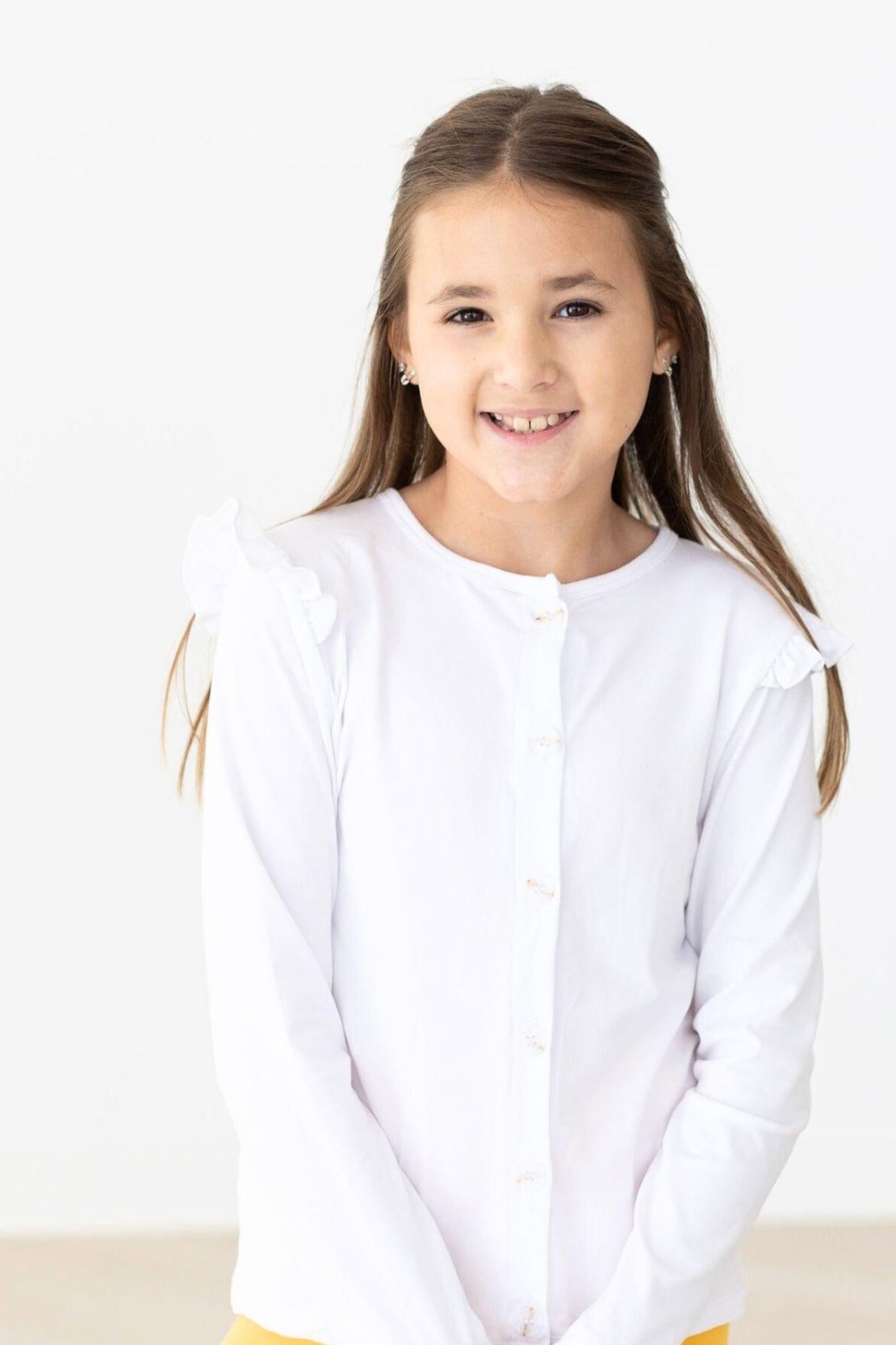 White button-front cardigan with ruffled collar and sleeves