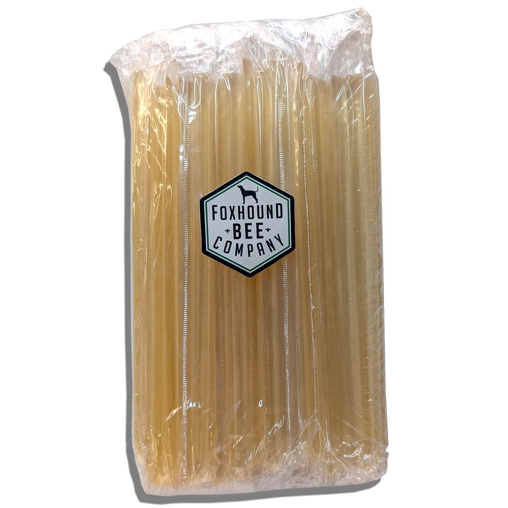 Roll of light amber honey sticks, sealed together in clear plastic wrap