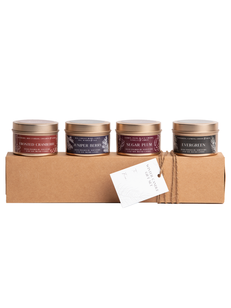 Candle gift set on kraft box with four tins in a row, with attached paper tag.