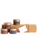 Winter candle gift set with four small tins and kraft box, includes price tag.