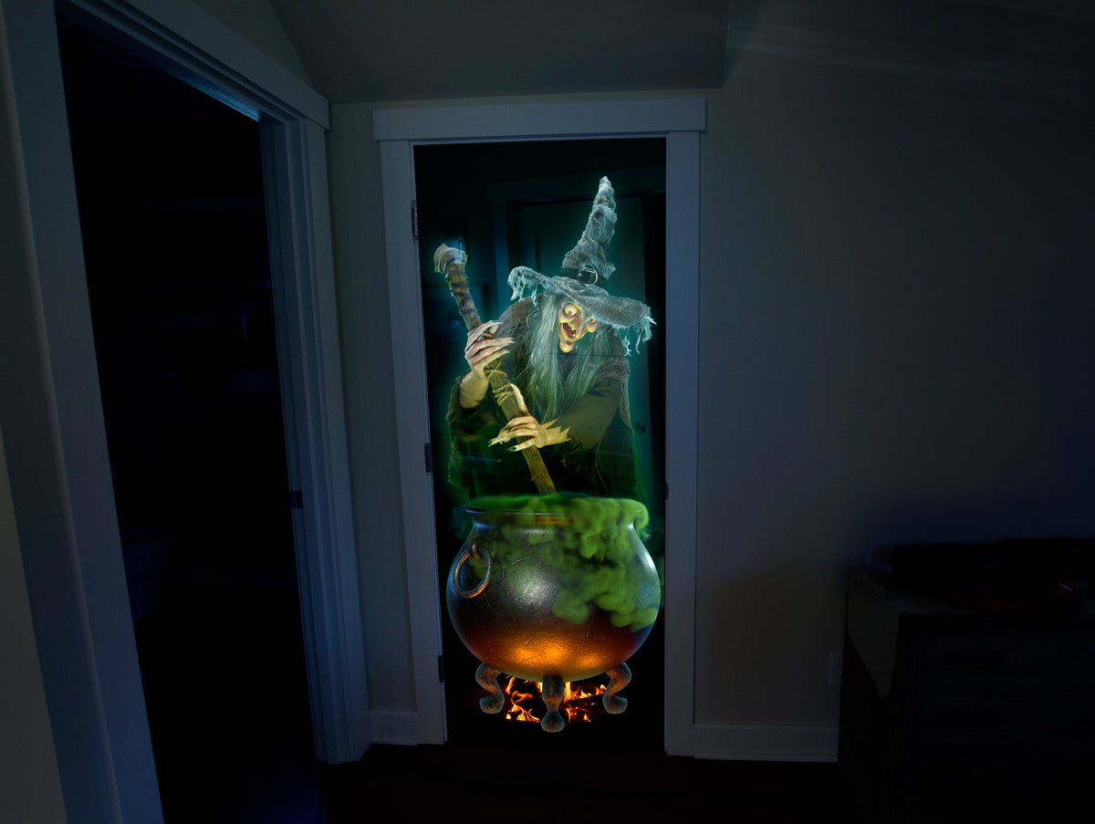 USB projector projecting a glowing cauldron witch scene onto a doorway