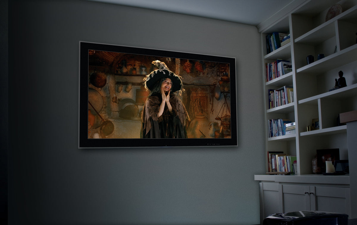 USB projector projecting a witch portrait scene onto an indoor wall