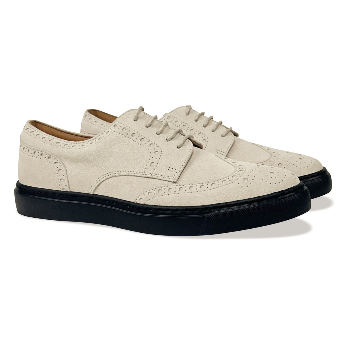 Ivory lace-up oxford shoe with brogue-style perforations and black platform sole