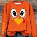 Orange women's crewneck pullover sweater with cartoon turkey face and glasses print