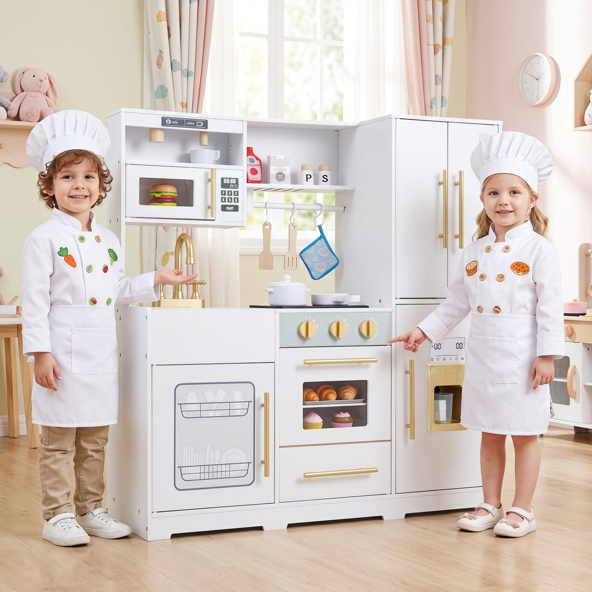 White wooden kids play kitchen with sink, stove, oven, and gold-tone handles