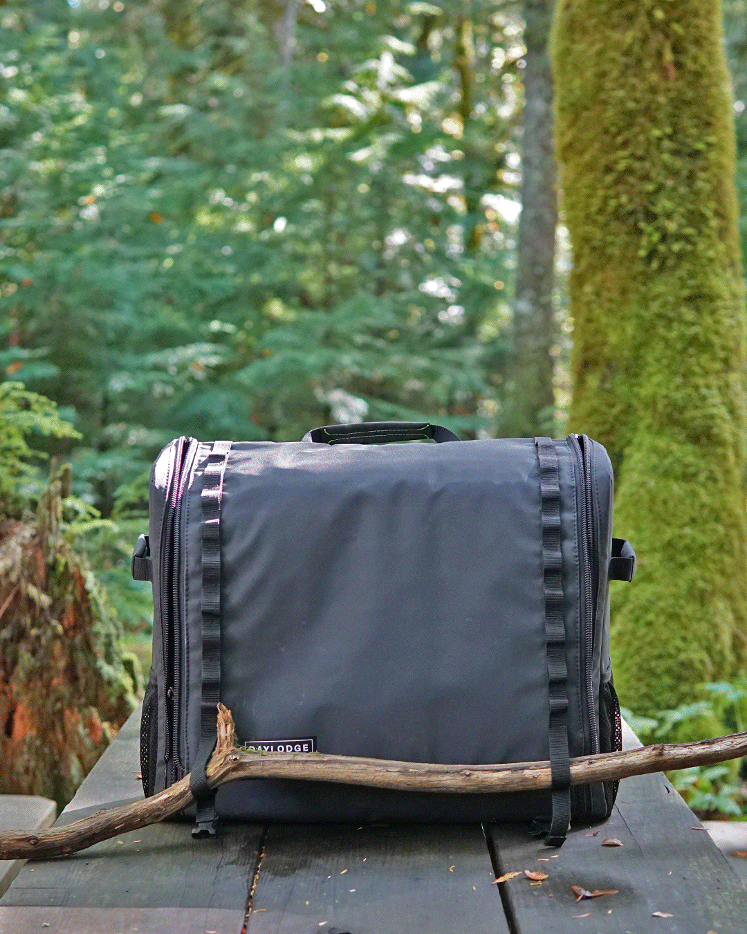 Dark navy mobile camp kitchen bag with side straps on an outdoor table