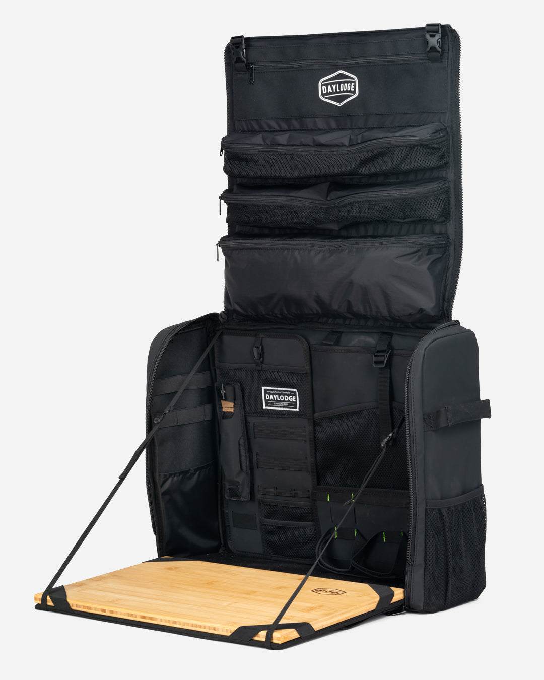 Black mobile camp kitchen bag with fold-out wooden table and stacked organizer panels
