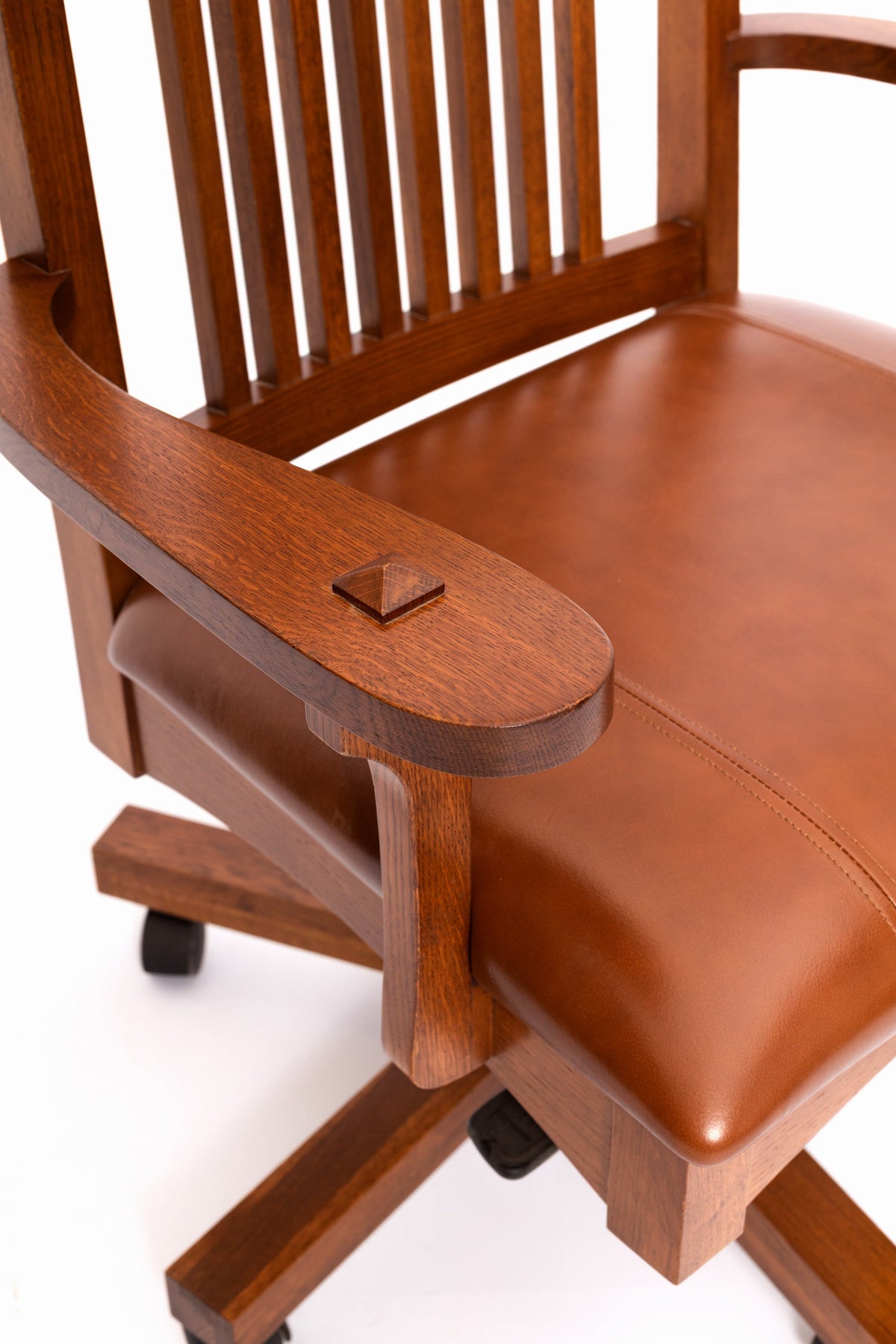 Mission oak office chair armrest and brown leather seat close-up