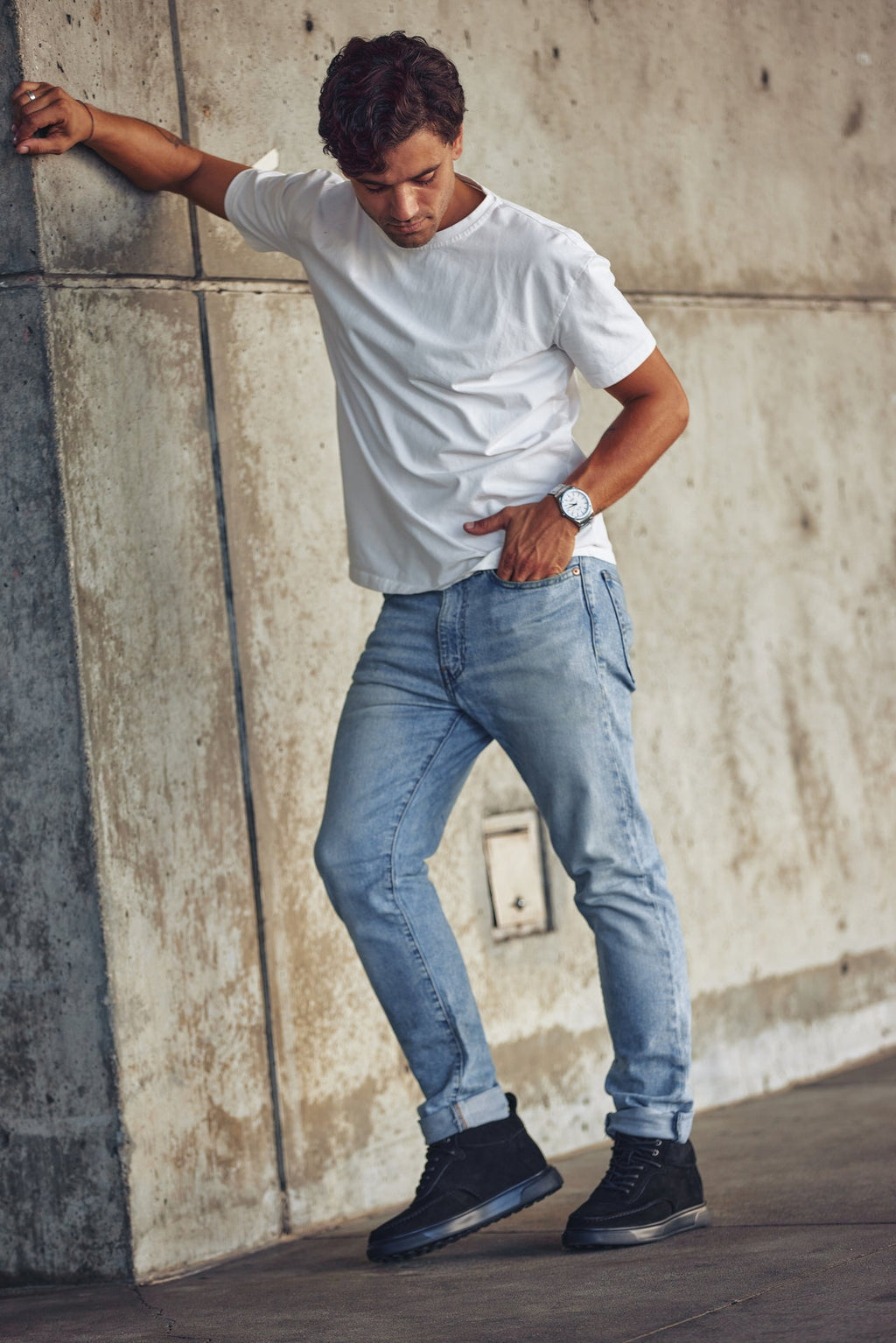Black lace-up sneaker boots on model, moc-toe design with rubber sole