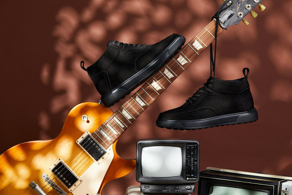 Black lace-up sneaker boots with moc-toe styling and thick rubber soles