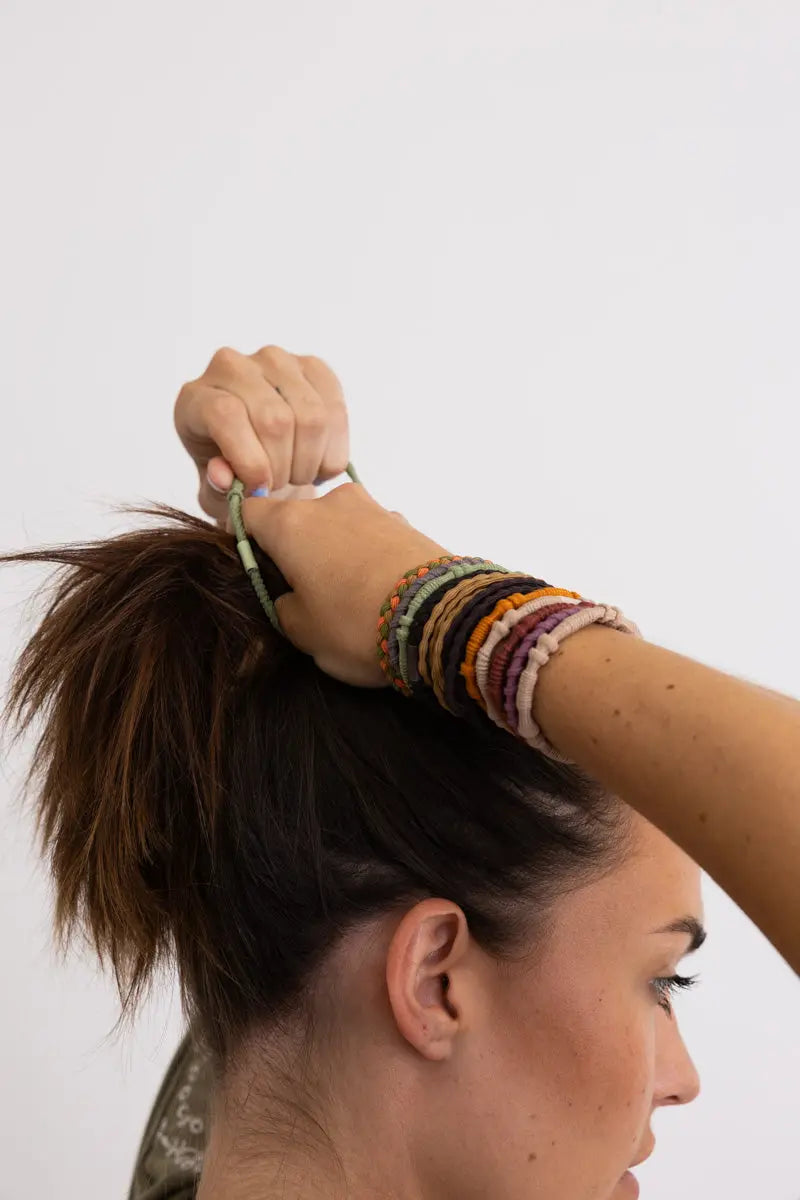 Braided hair tie bracelets, multicolor stacked on wrist