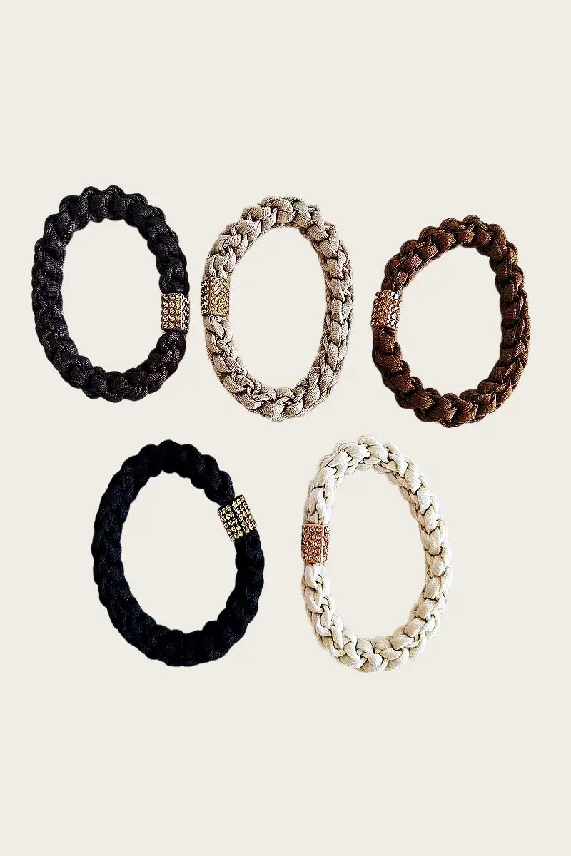 Five braided hair ties in dark, beige, brown, and cream with jeweled center cubes.