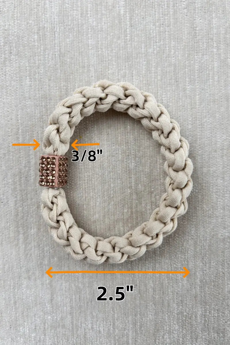 Beige braided hair tie with rhinestone-like center charm; approx 2.5 in length.