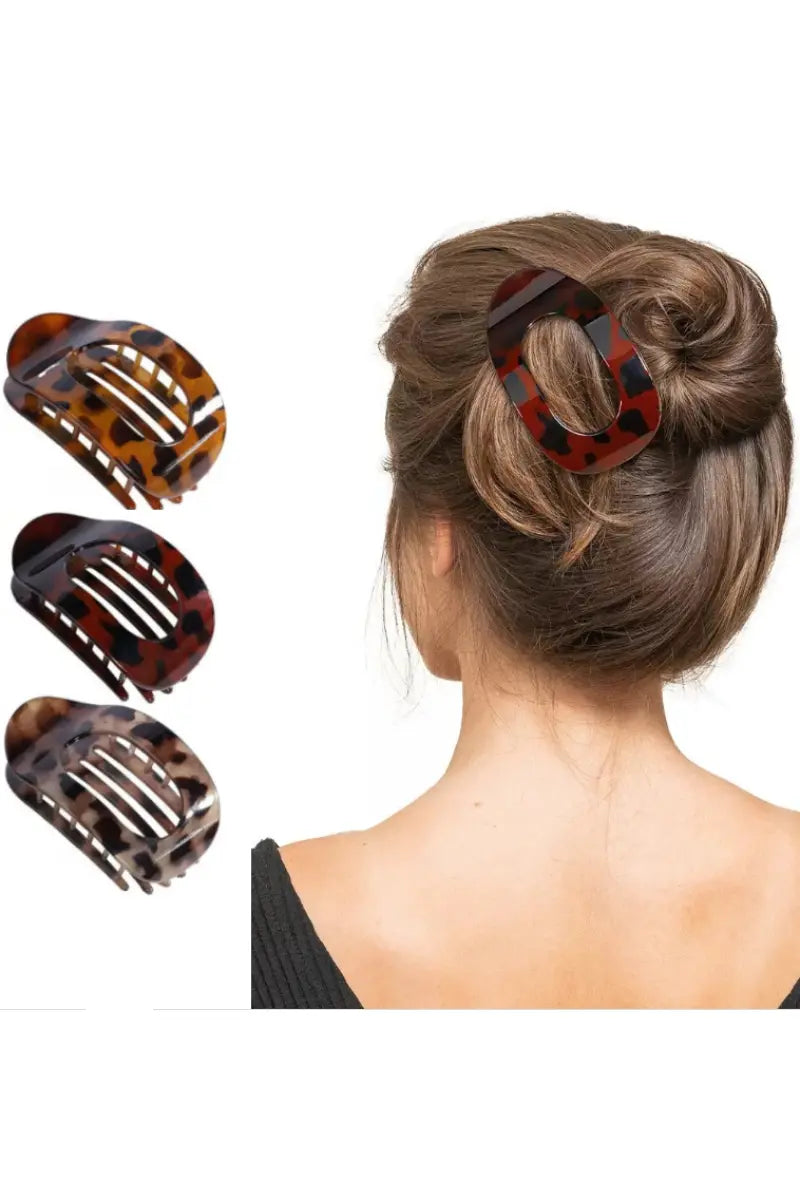 Tortoiseshell arc hair clip with cutout baroque design, holding a messy bun updo