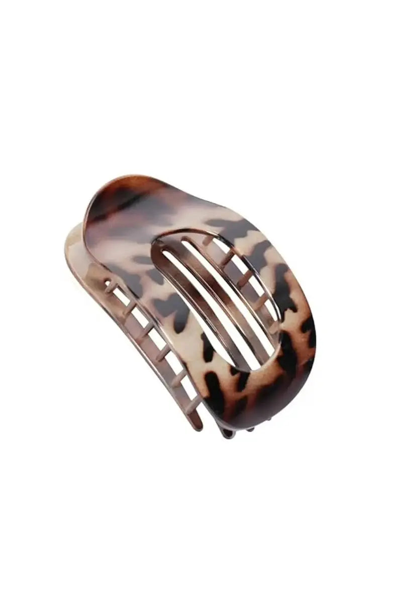 Dark tortoiseshell arc hair clip with three-bar cutout and metal prongs