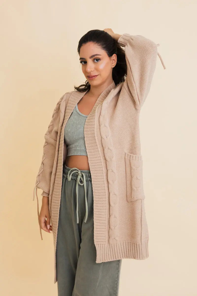 Khaki cable-knit cardigan with open front, ribbed cuffs, drawstring sleeve ties