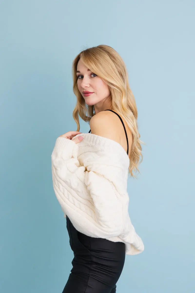 Ivory cropped cable-knit button-up cardigan, off-shoulder side view with cable texture