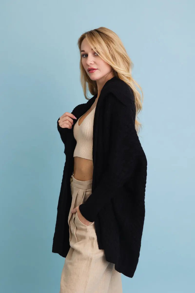 Chunky cable-knit poncho cardigan in black, side drape with open front