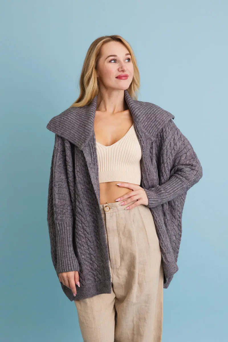 Chunky cable-knit poncho cardigan in gray, draped open front with chunky texture