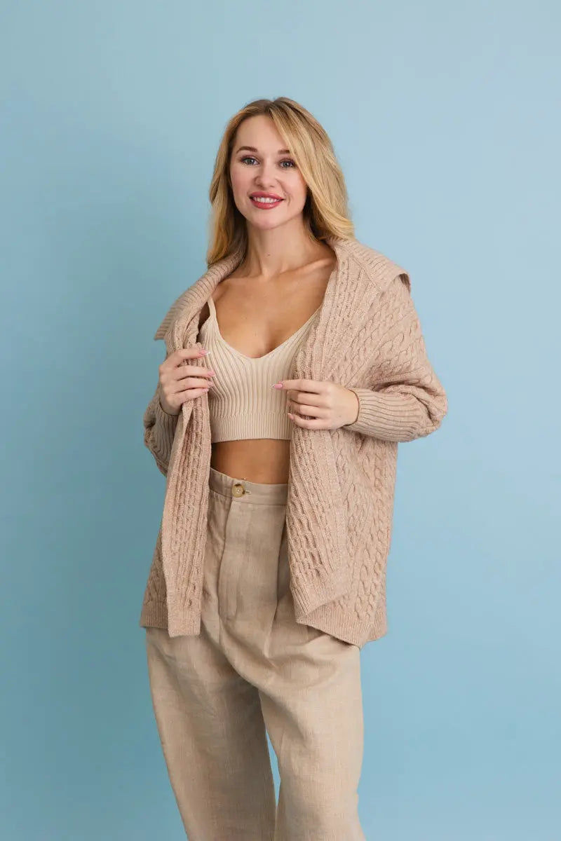 Chunky cable-knit oversized poncho cardigan in oatmeal beige, open front with draped collar