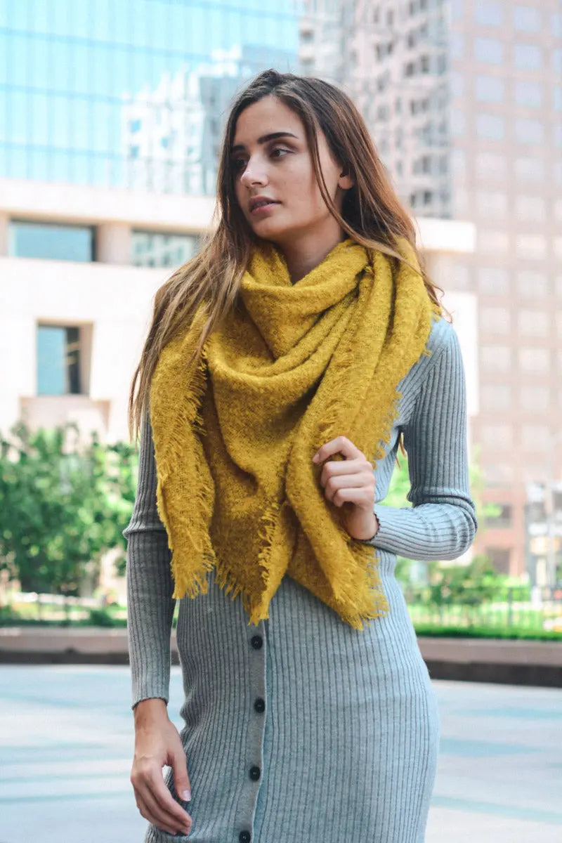 Mustard yellow plush mohair square scarf with soft drape and fringed ends.