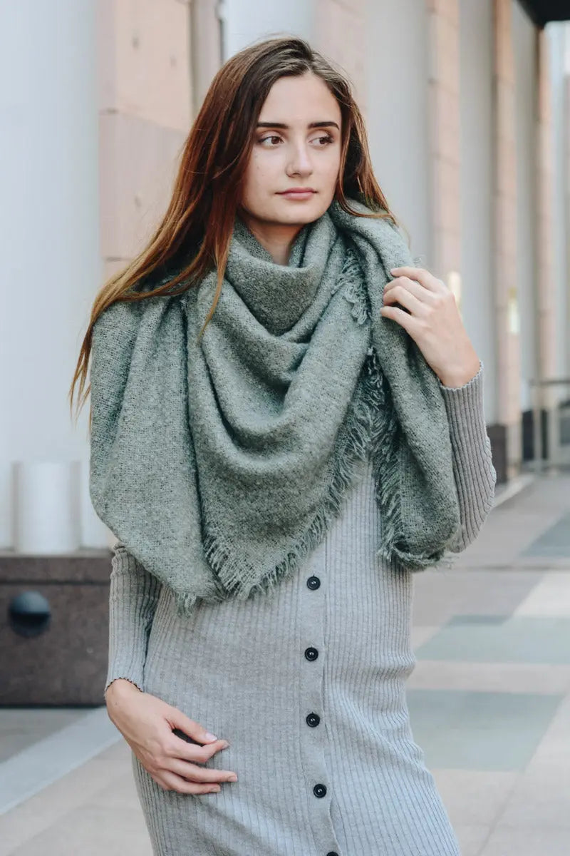 Sage plush mohair square scarf with draped cowl shape and fringe trim.