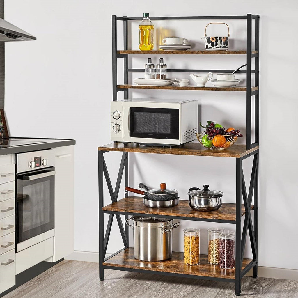 Kitchen bakers rack with open shelves, black metal frame, and wood tabletop
