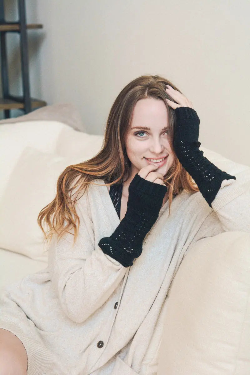 Black knit texting-friendly arm warmers with open-knit fingertip openings