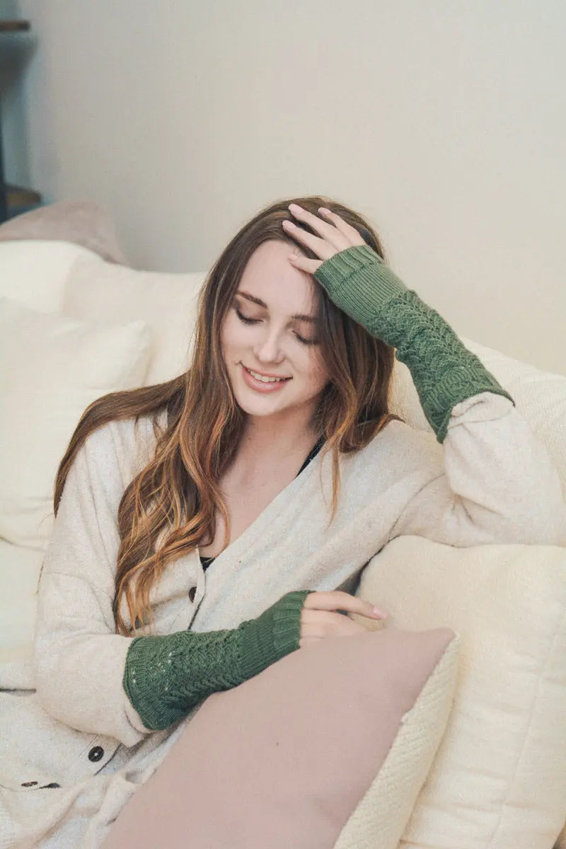 Sage green knit texting-friendly arm warmers with ribbed cuffs