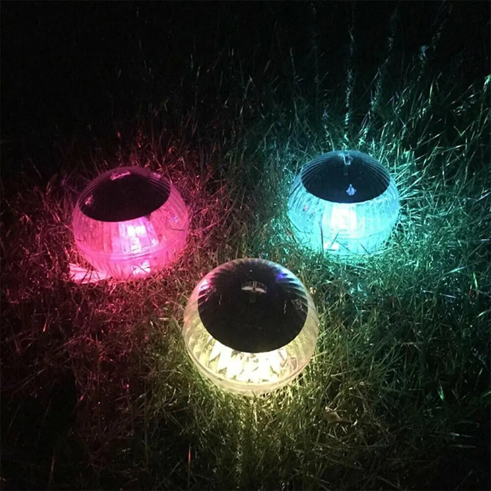 Solar LED floating dome lights in pink, blue, and warm white glow