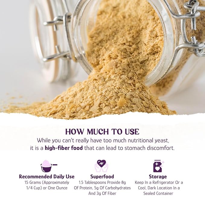 Nutritional yeast flakes in a glass jar with loose flakes spilling out.