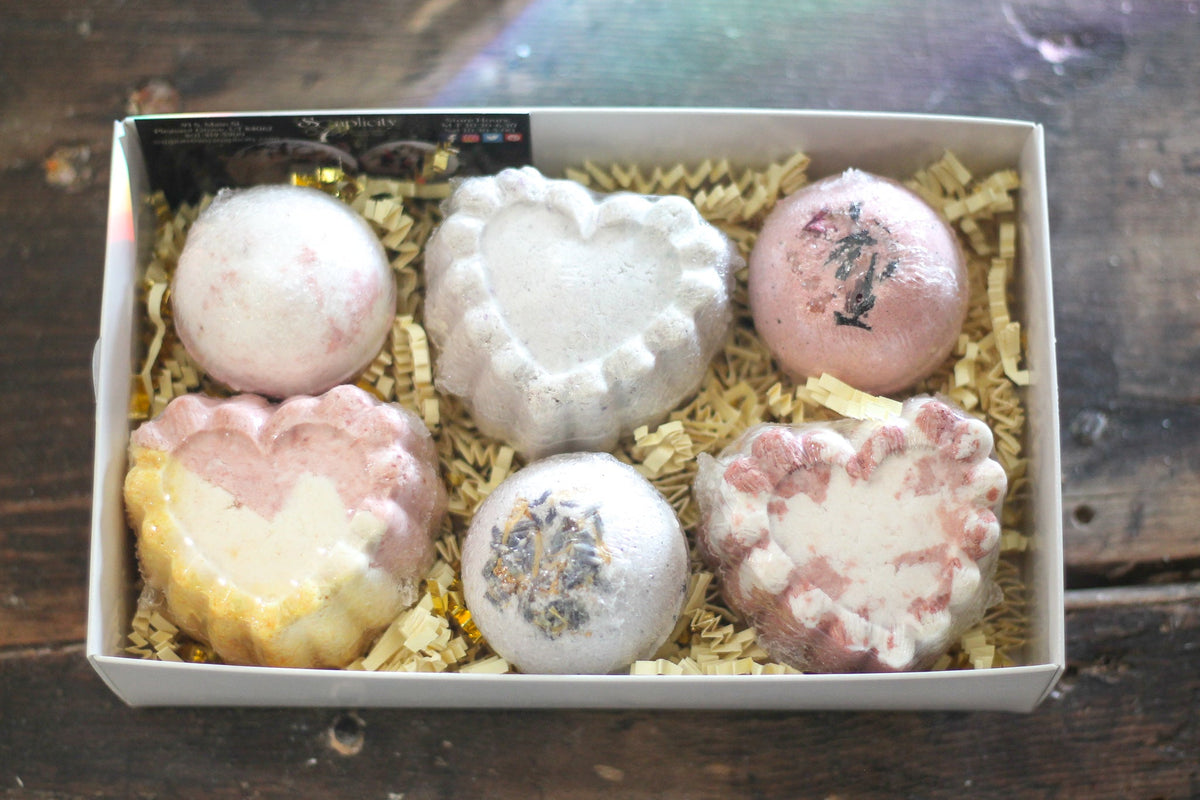 Heart-shaped bath bomb gift set in open box with assorted bombs