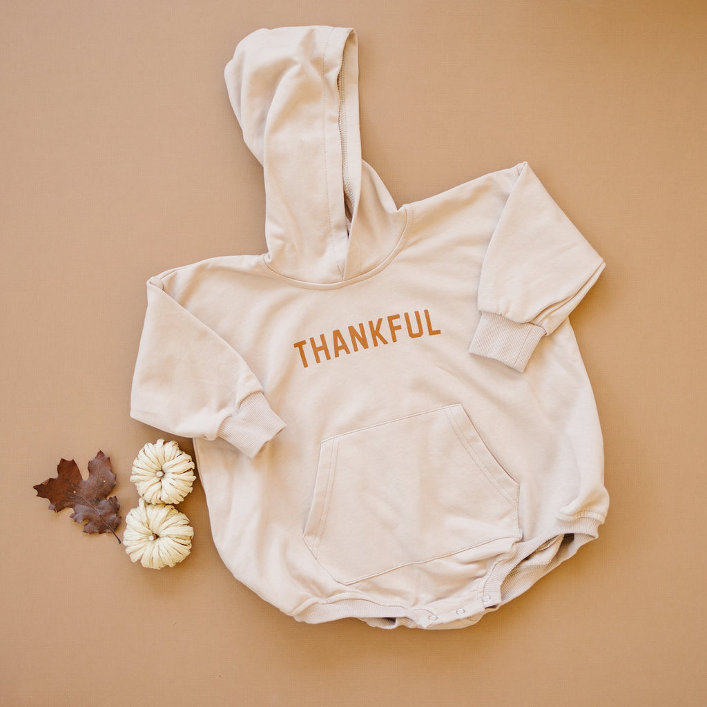 Hooded sweatshirt romper with kangaroo pocket and 'THANKFUL' logo print, long sleeves